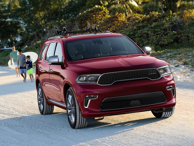2024-Dodge-Durango-SXT-SUV-L04.png red Dodge Durango SXT parked on the beach sand