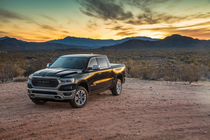 black Ram 1500 parked on dirt, with a sunset in the background