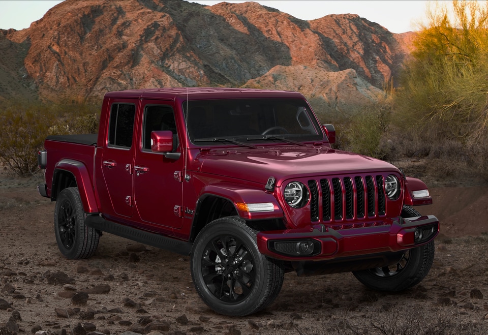 maroon Jeep Gladiator truck parked on a rocky ledge