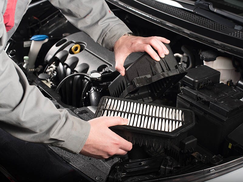 Service Technician replacing engine air filter