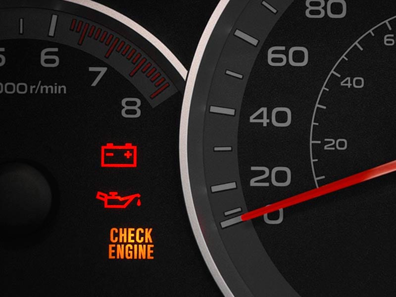 Car gauges displaying check engine light.