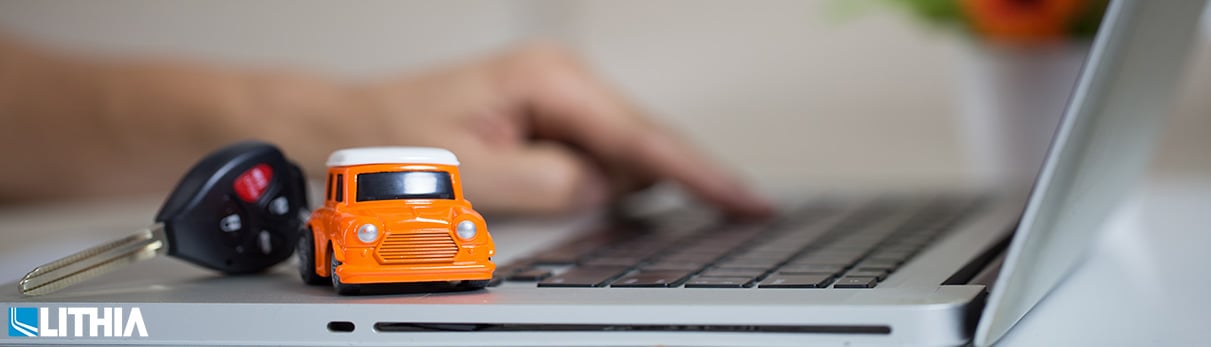 Toy car sitting on a laptop