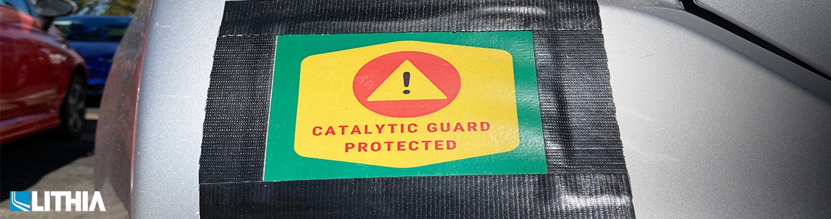 Catalytic Guard Protected sign on vehicle bumper