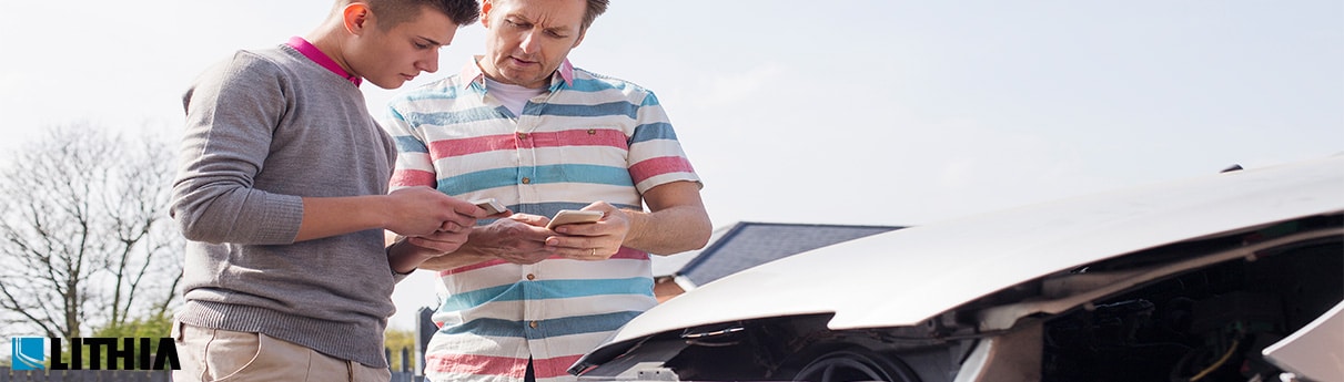 Two men checking documents on a accident