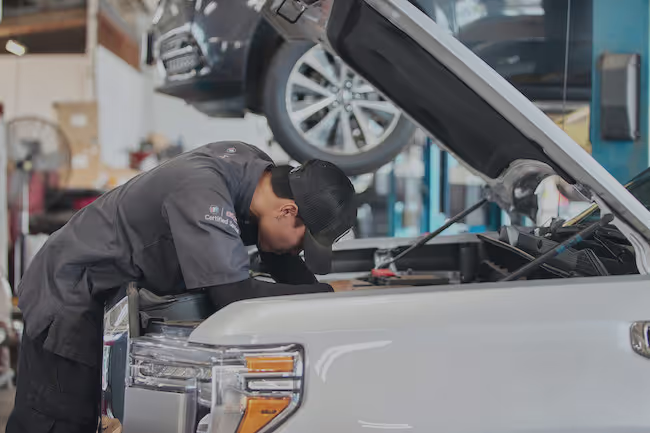 Technician servicing a GMC vehicle