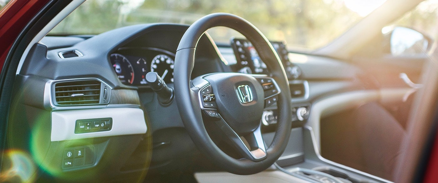 black dashboard interior of a Honda Accord, steering wheel prominent
