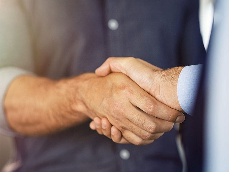 Two people shaking hands.