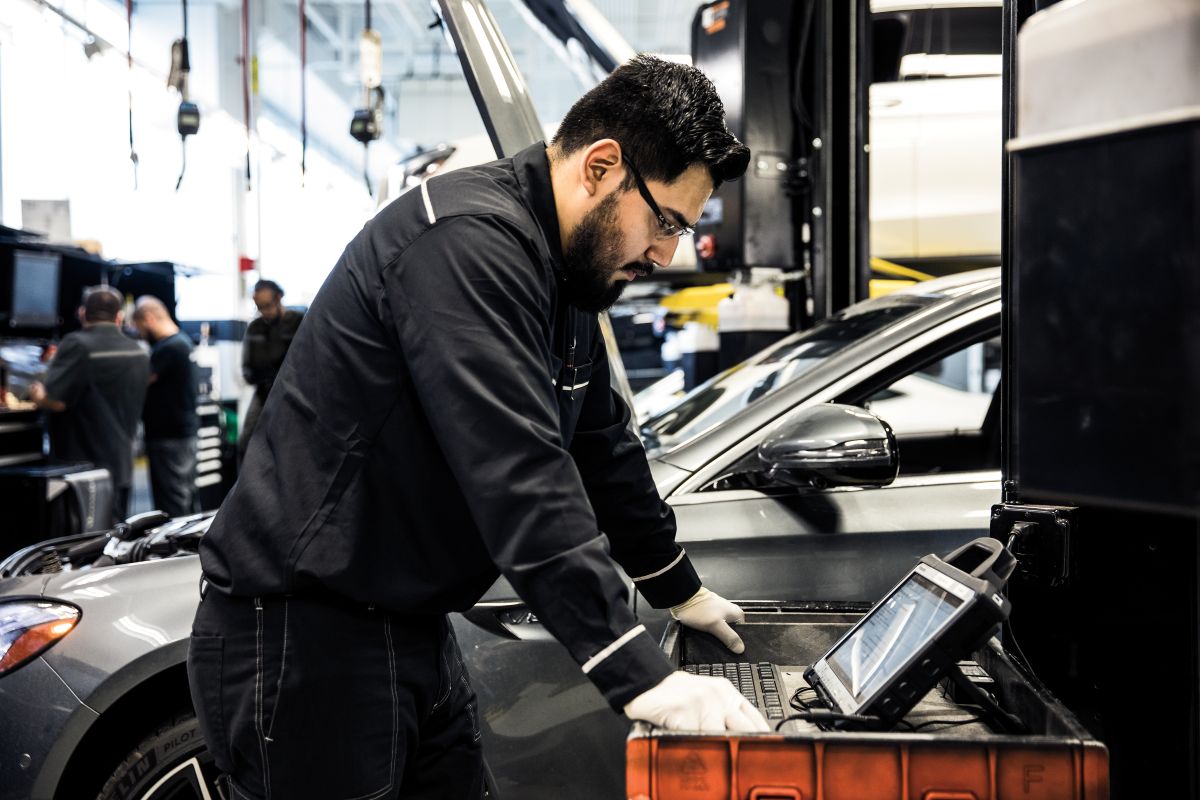 Mercedes-Benz technician performing vehicle diagnostics