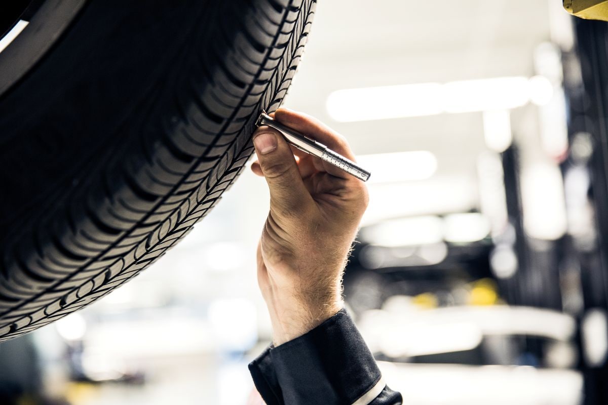 Mercedes-Benz technician inspecting a vehicle tire
