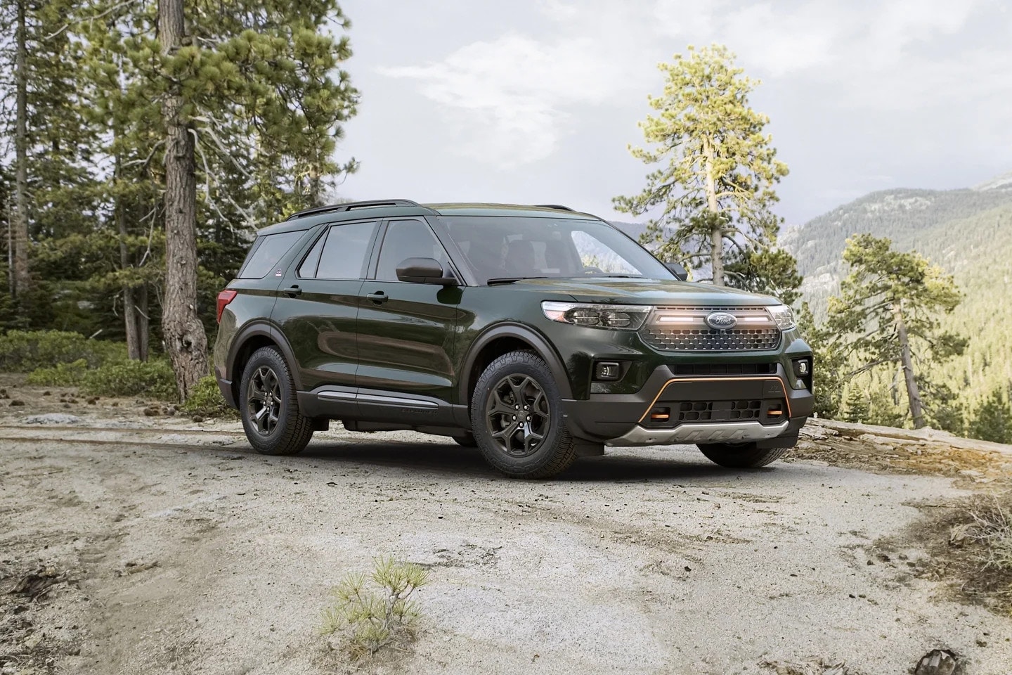 green Ford Explorer SUV parked at a trailhead