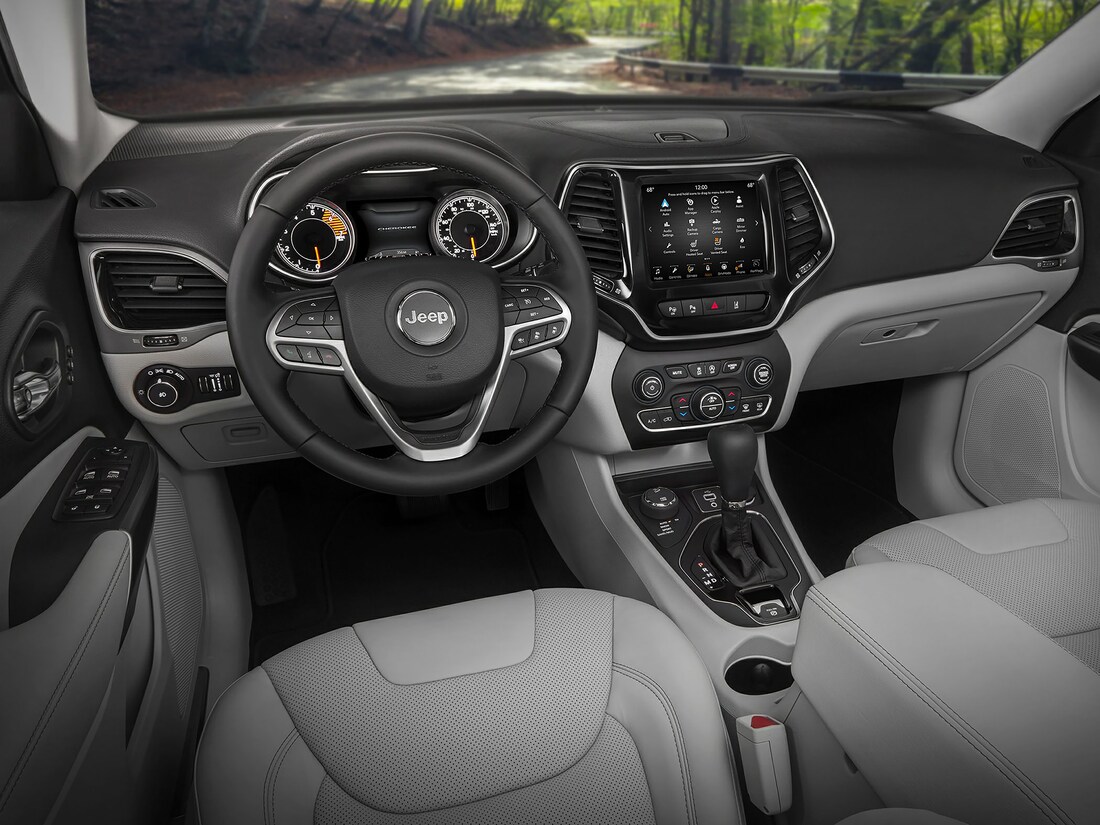 black and gray Jeep Cherokee SUV interior steering and dash board area