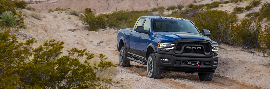 blue Ram 2500 Power Wagon truck parked on a rocky ridge