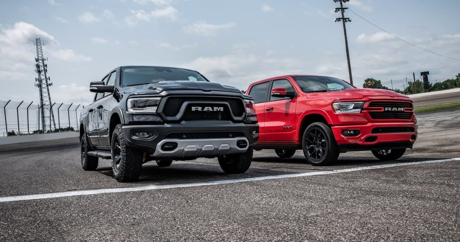 red and black Ram 1500 trucks parked at a starting line