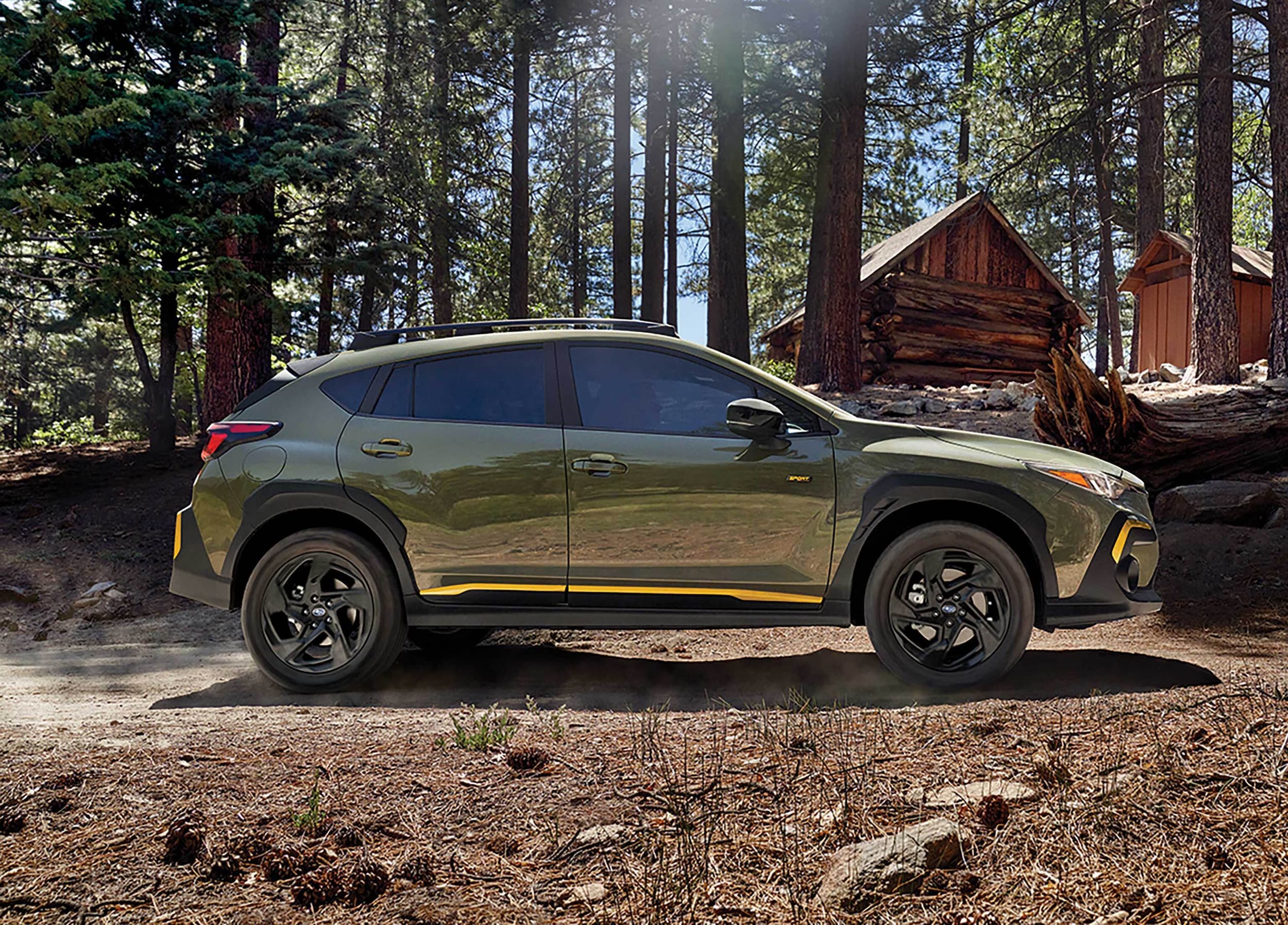 2024-Subaru-Crosstrek-Wilderness-SUV-L05.png blue Subaru Crosstrek Wilderness parked in the woods