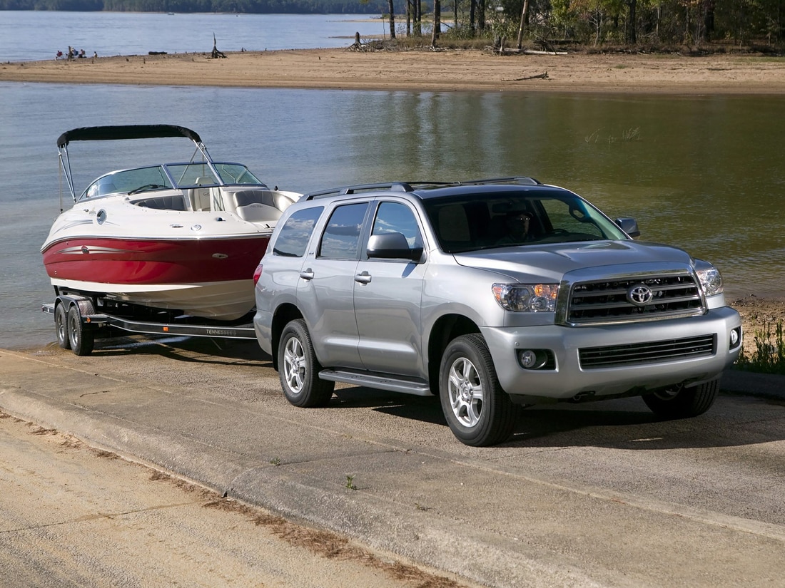 silver Toyota Sequoia towing a boat