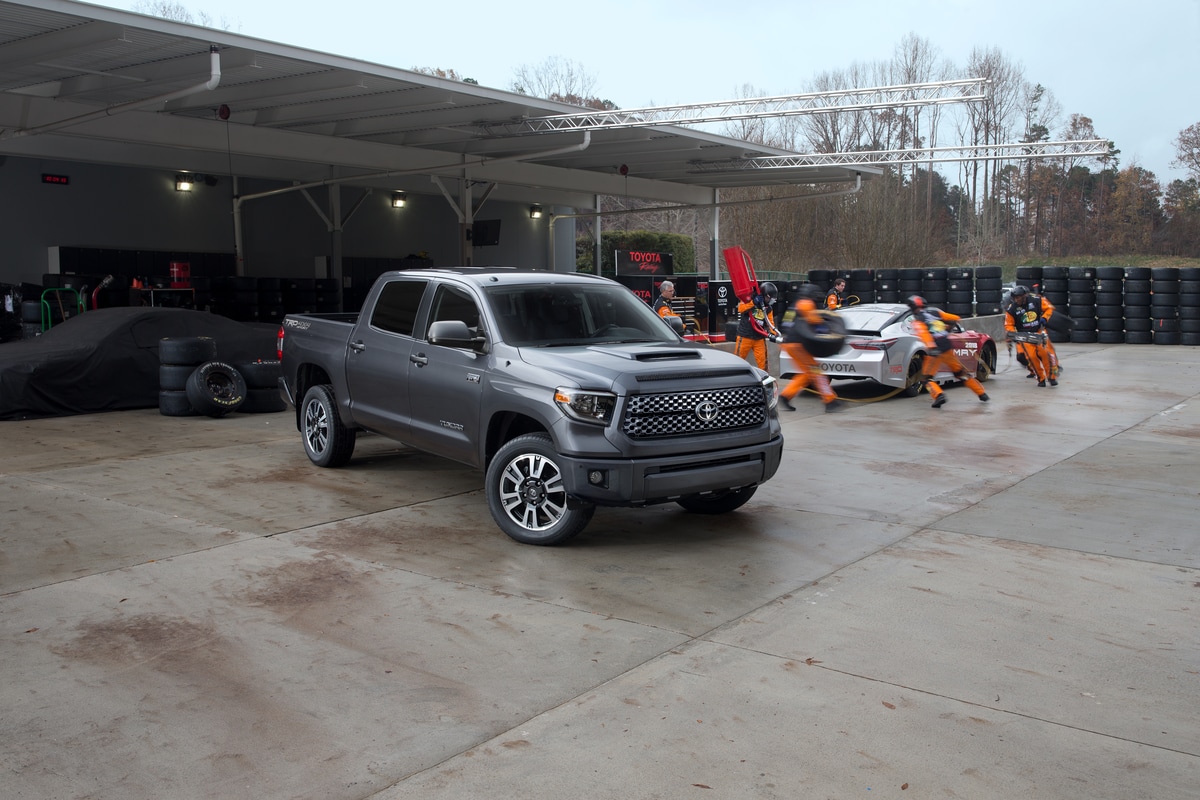 dark gray Toyota Tundra truck parked in front of a tire shop
