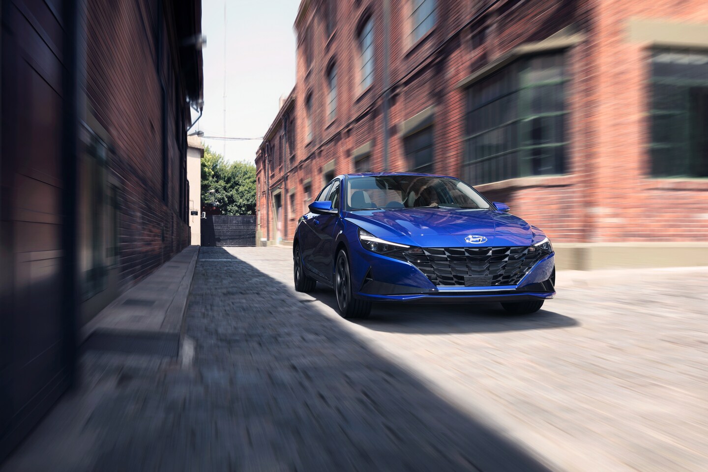 silver Toyota RAV4 SUV driving on a forest trail, towing a teardrop trailer