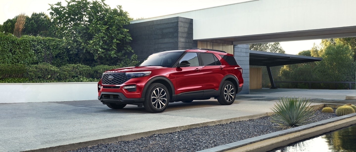 red Ford Explorer parked in front of a minimalist home