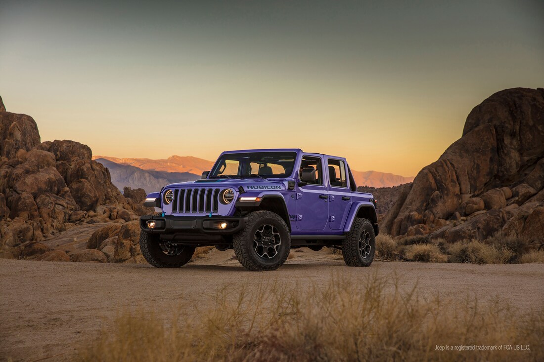 purple Jeep Wrangler Unlimited Rubicon SUV parked in a desert