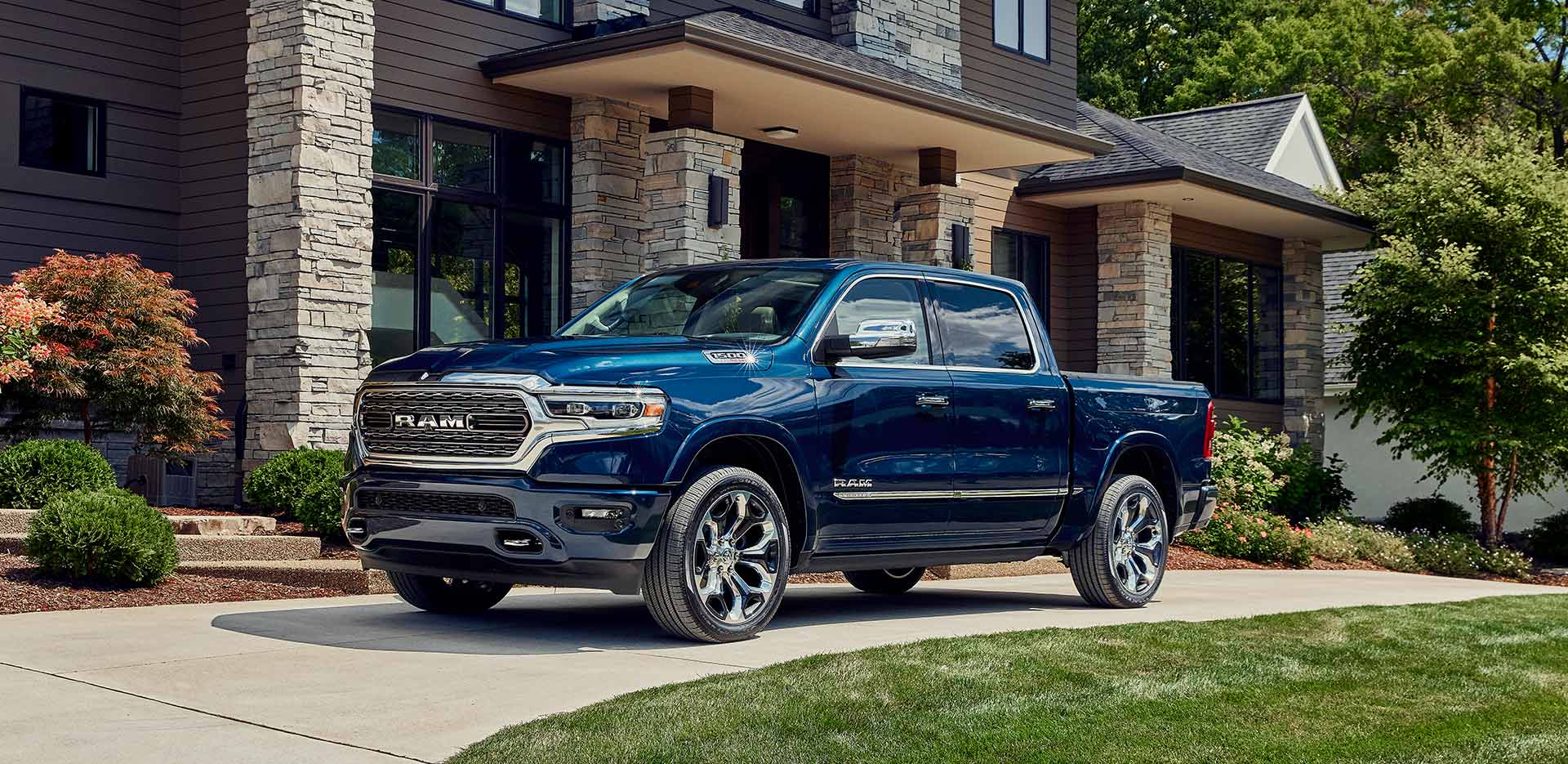 blue Ram 1500 truck parked in front of a new home