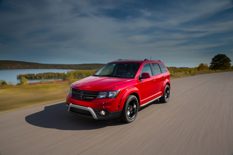 red Dodge Journey SUV driving down the highway