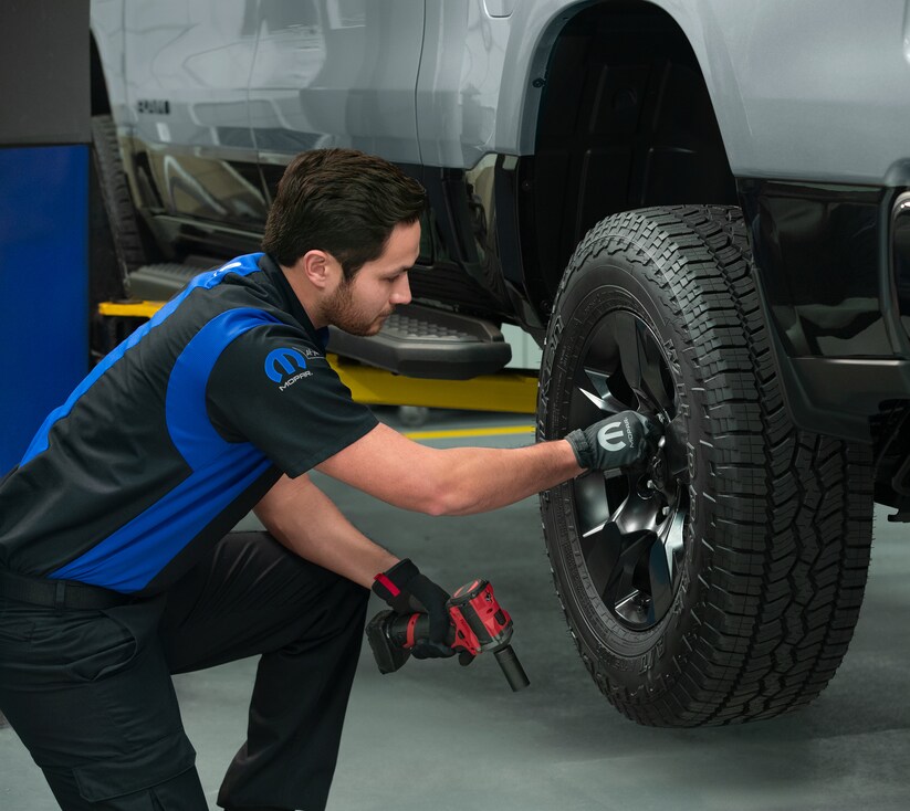 RAM-Service-03.png Mechanic replacing the bolts on a Ram wheel