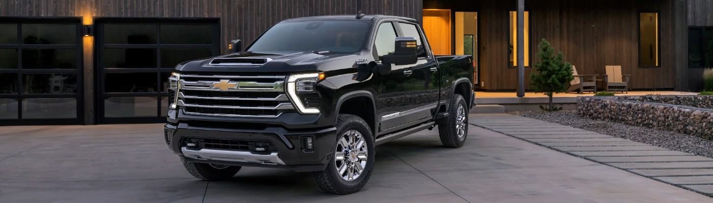 Chevy Silverado HD High Country parked in front of a modern home