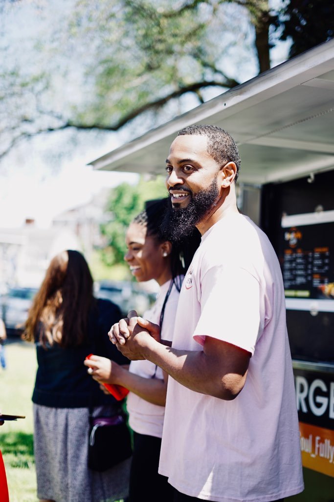 a picture of Calvin and Allison standing outside of their food truck.