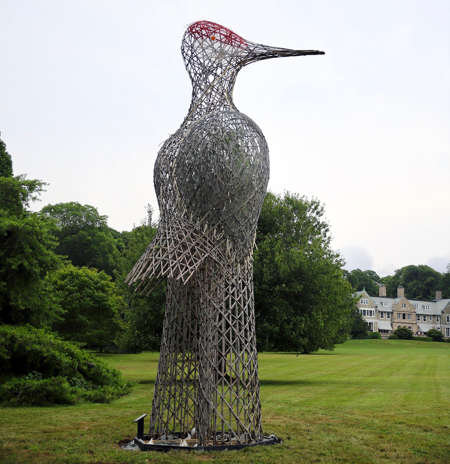 Large bamboo crane with red bamboo on its head.