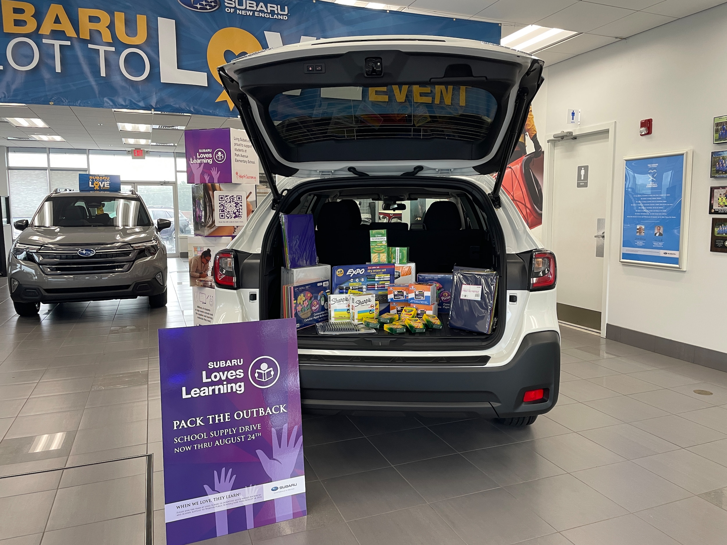 A white outback filled with school supplies from customers and employees. 