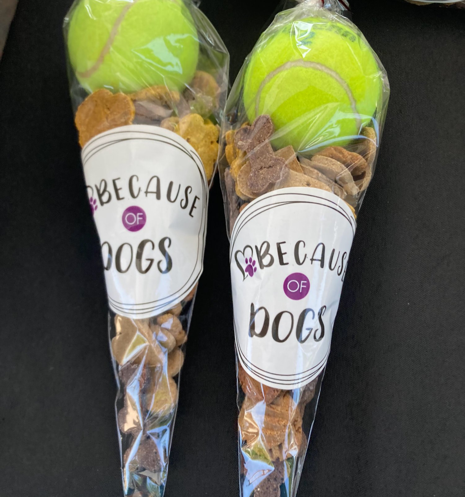 Tennis ball and dog cookies in a cone bag.