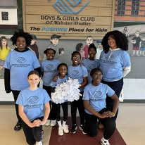 a group of 8 girls part of the dance team at the BGCWD. wearing blue shirts and holding white pom poms