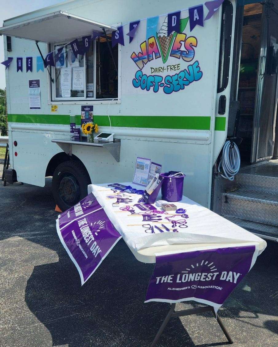 Waves ice cream truck and a table set up for donations