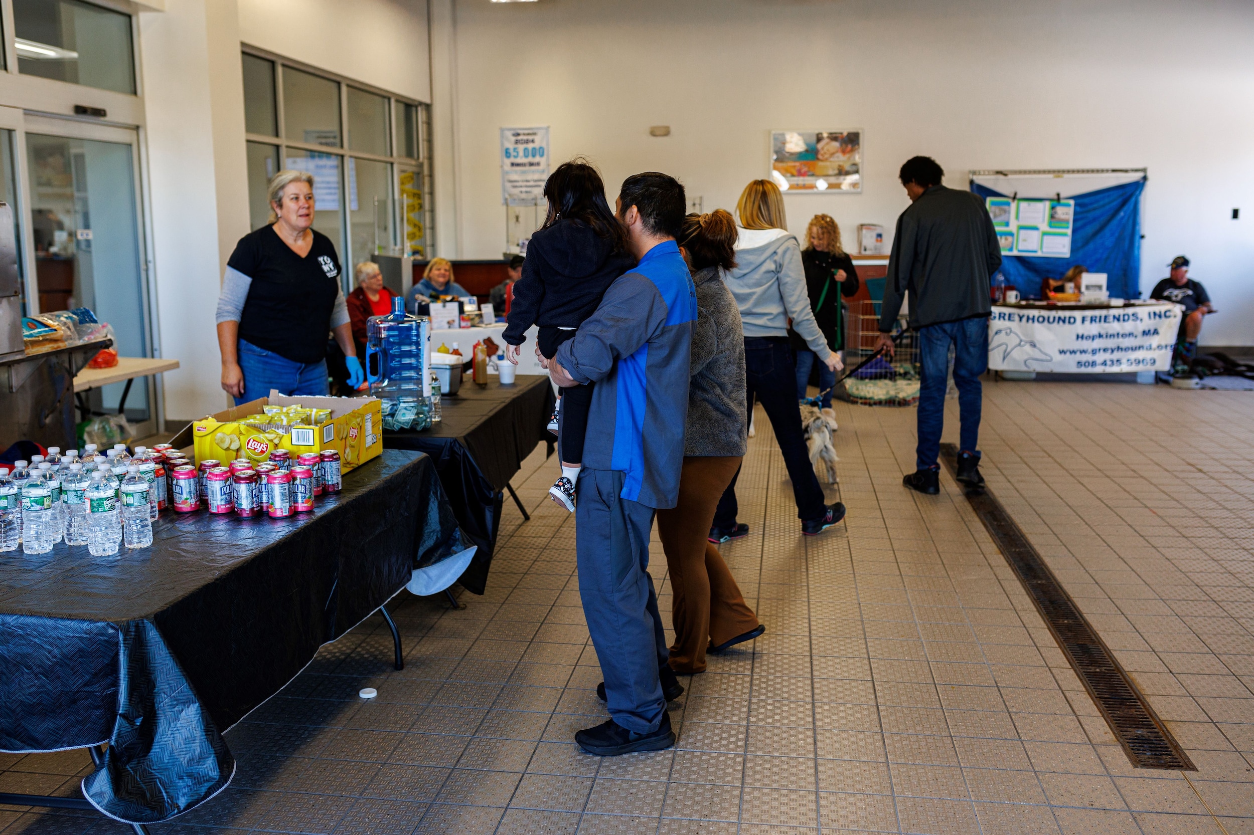 People waiting for their hot dogs in the Long Subaru Service bay.