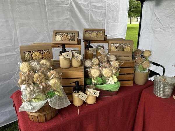 Handmade soap in the shape of flowers sitting on top of wooden crates.