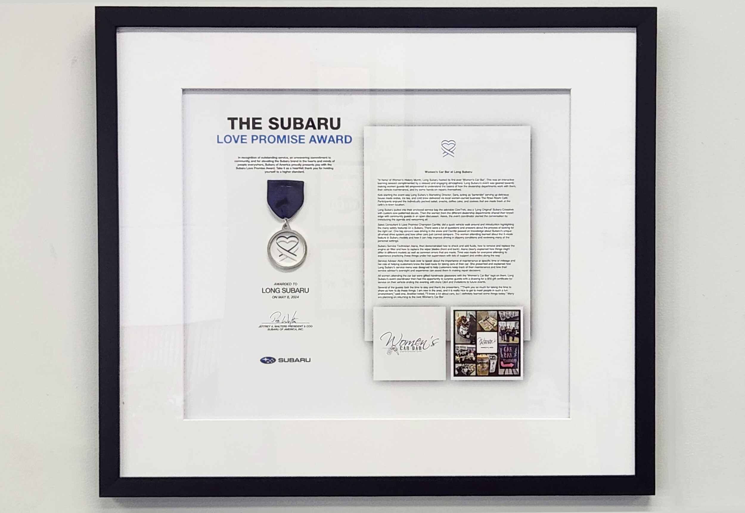 The Love promise award encased in a frame with the story of the Women's Car Bar