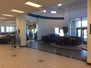 Main entrance of the dealership with cars inside