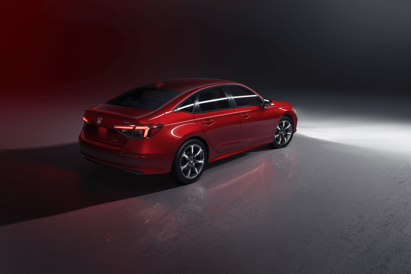 Red Honda Civic in dim lit showroom