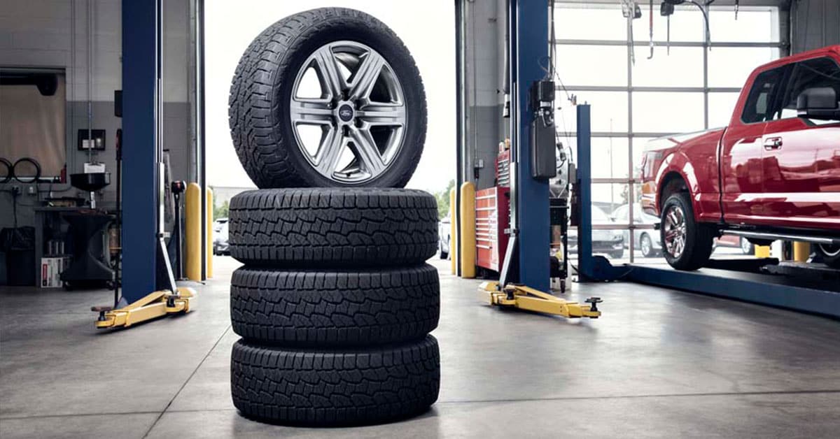 Ford tires stacked up in service bay.