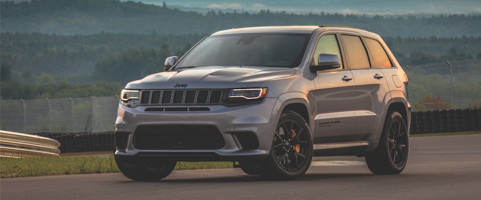 Jeep Grand Cherokee A silver Jeep Grand Cherokee parked on a track