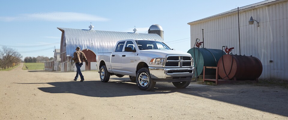 2019 Ram 2500 A man walking away from his white 2019 Ram 2500