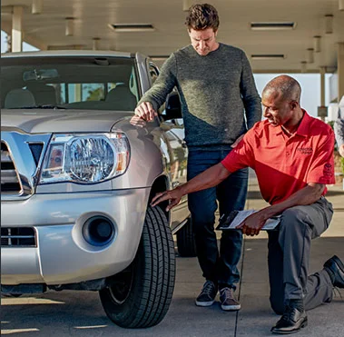  Service technician putting on a new Toyota tire.