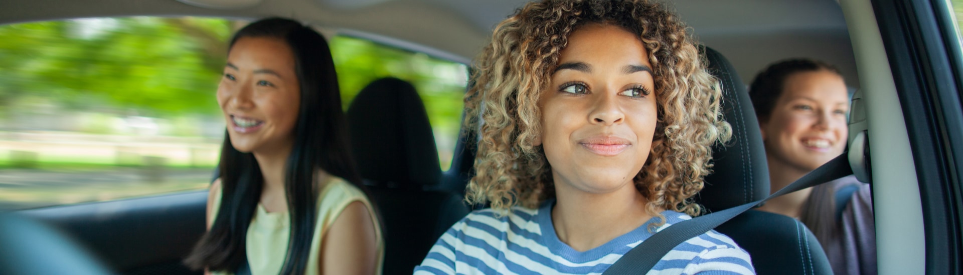 Three friends in a new vehicle
