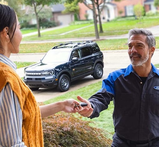 Maguire's Ford of Hershey Technician picking up the vehicle's key from customer