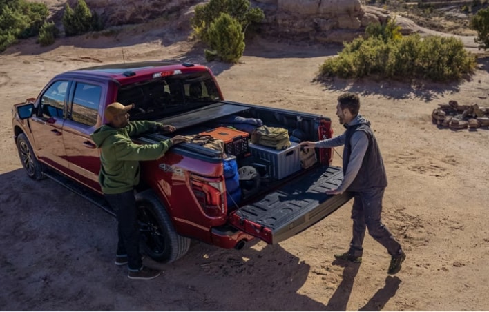 Man unloading his gear from his ford truck