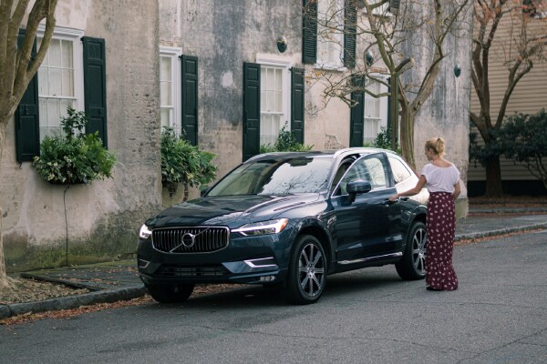 New VOlvo XC60 outside a building with a women walking up to it