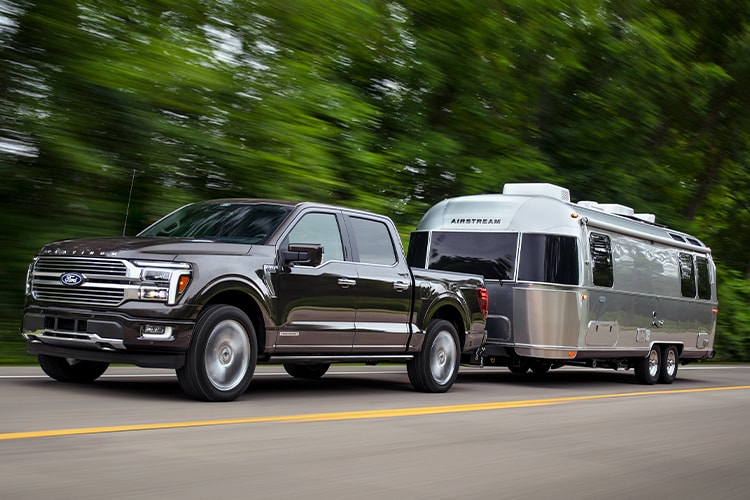  2024 Ford F150® PowerBoost® Hybrid pickup being driven on an open road