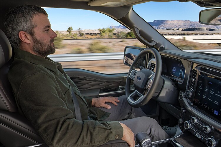 2024 F-150® Raptor R™ being driven in the desert kicking clouds of sand