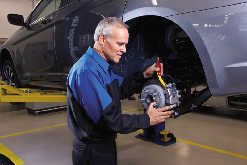 Mechanic Checking Brake Rotors
