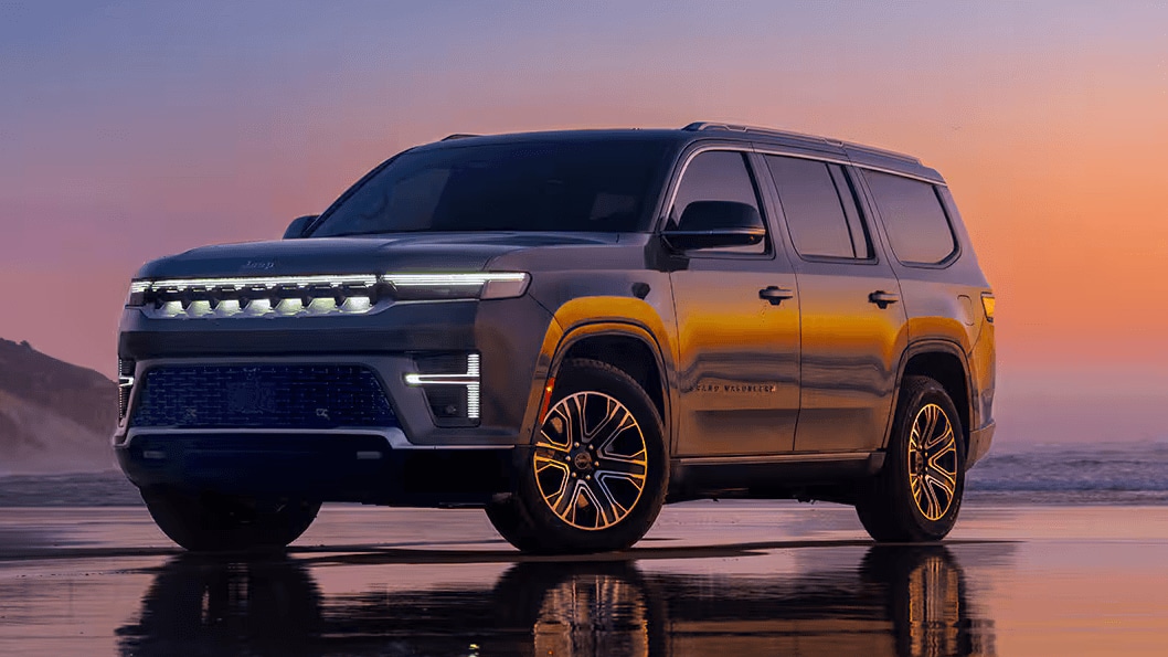 A Jeep Grand Wagoneer parked on a beach